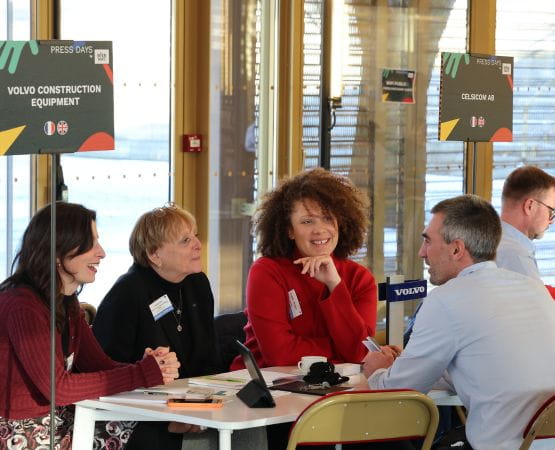 Professional group made up of one man and three women talking at the Intermat press day