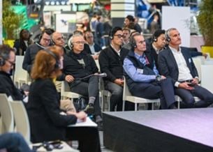 Attendees listening to a presentation at a trade show