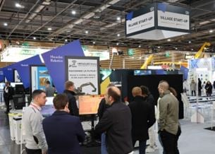 Visitors exploring booths in a trade show Startup Village