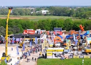 Outdoor area with construction machines and equipment, visitors present