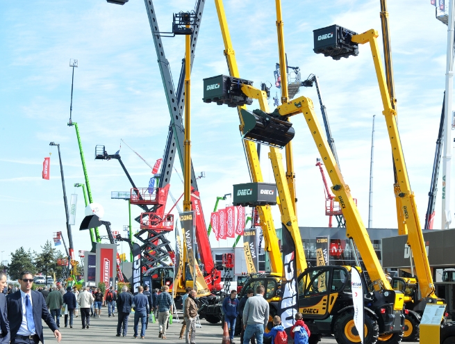 Various brands of forklift trucks gathered outdoors at INTERMAT