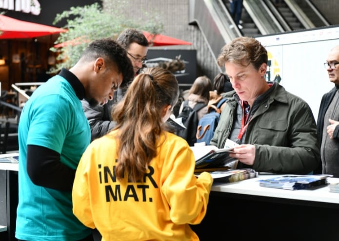 Attendees interacting at a trade show booth